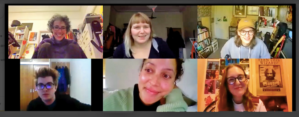 6 people take part in a zoom workshop session, each from their own different spaces: they include a white woman with dark curly hair, a white woman with long blonde hair, a white man with long brown hair and glasses, a white man with spiky red hair and glasses, a mixed race woman with dark hair and a white woman with long hair and glasses.