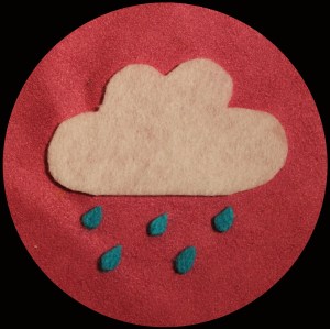 A felt image of a weather symbol cloud with rain drops